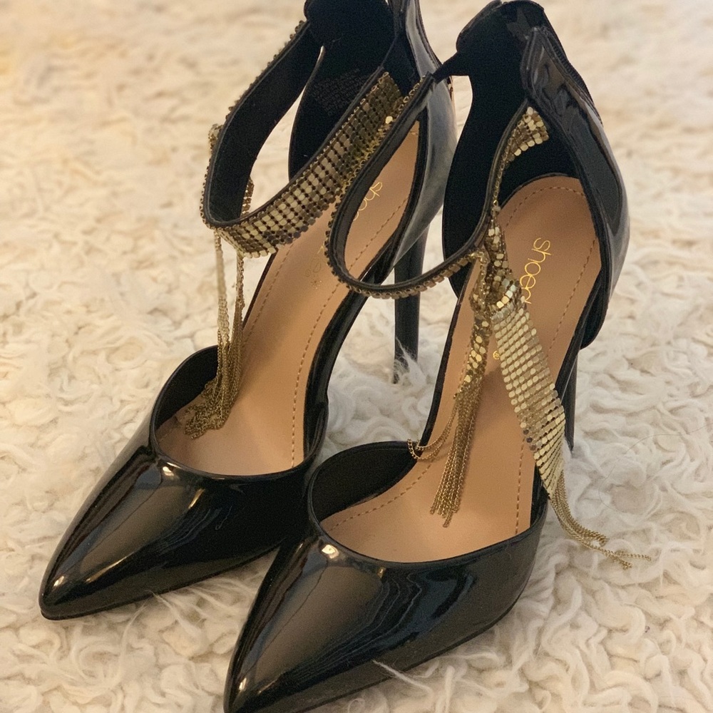 Black patent leather shoes with gold detail